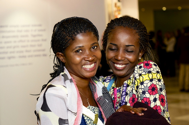 Marceline Kongolo (left) relaxes at the exhibition with a friend.