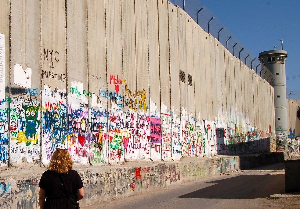 A section of the wall along the border of Bethlehem. Here the wall is 8 meters (roughly 26 feet) high and has many military towers along it. Many families describe how the wall went up outside their homes in a matter of a day, with absolutely no warning. 