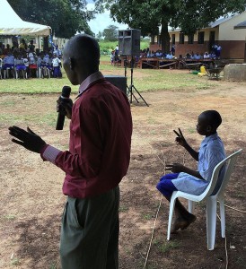 P-5 Student Okumu Luriu Translating a Speech into the Local Sign Language for his Parents in the Crowd