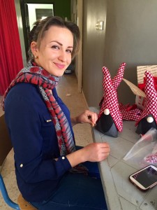 The Kafia Gnomes, a bestseller of the Hope Workshop, with one of the beneficiaries. 